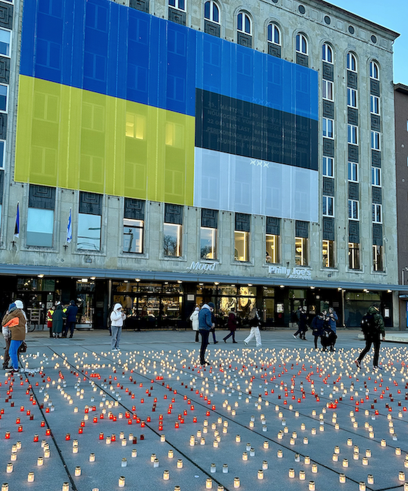 Ukraine and Estonia flags appear side by side in Tallinn's Freedom Square. One thousand candles cover the floor of the square commemorating Ukraine's resistance to Russian aggression.